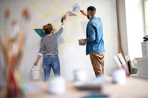 2 people painting a wall