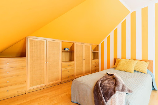 bright yellow rooms with a slanted ceiling