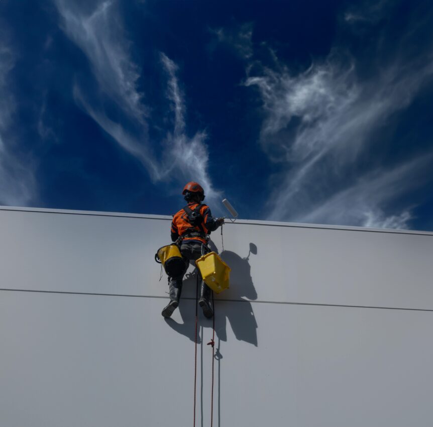 Man painting building wall